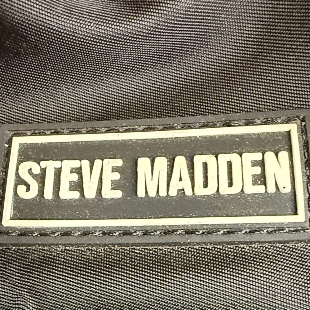 Steve Madden Bjodah Black Quilted Backpack with carry handles and branded strap